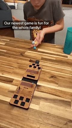 Portable wooden dice game being played on a kitchen table